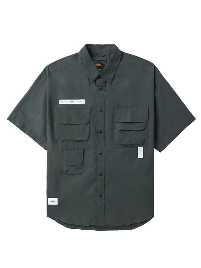 UNFRM Nylon Utility Shirt by Alpha Industries in teal, nylon material, short sleeves, button-up front, chest patch pockets, two lower front pockets, small white label with silicone Alpha print on left chest.