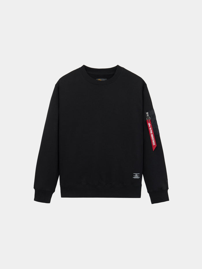 Alpha Industries Utility Pocket Crewneck in black with ribbed cuffs, hem, and MA-1 utility pocket on left sleeve with red tag.