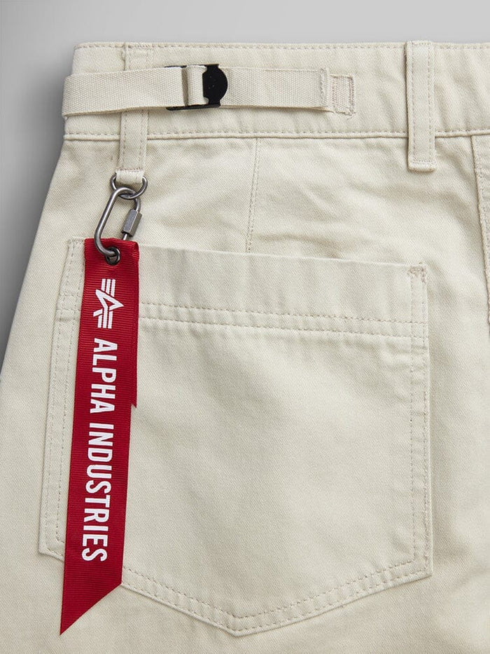 Alpha Industries Womens M-65 Cargo Pant in Limestone, military-inspired cargo style, back pocket, belt detail, red keychain with metal clip.