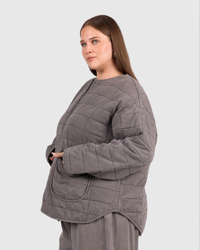 Woman wearing quilted winter charcoal jacket with pockets